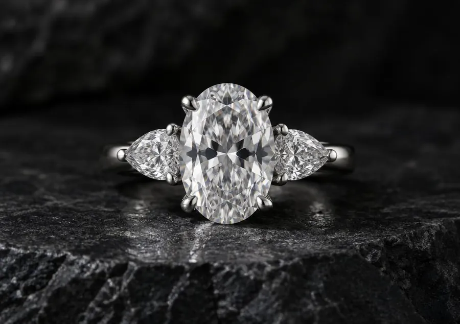 Oval diamond engagement ring with pear side stones