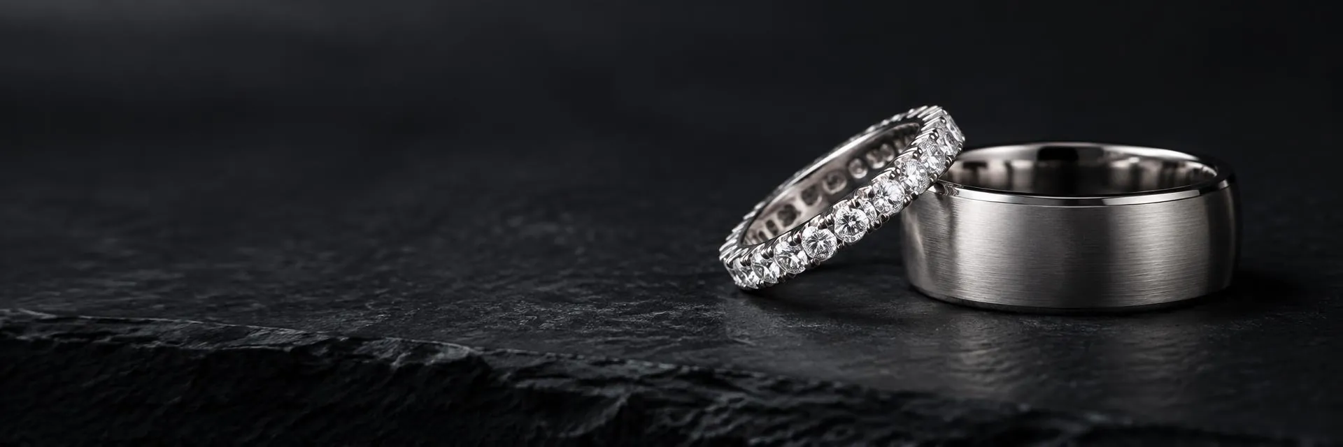 Diamond eternity band and brushed platinum band on slate